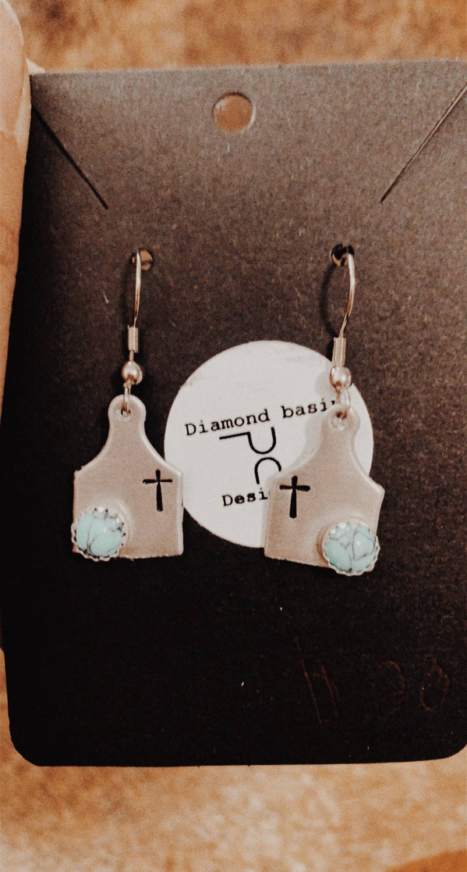 Cross cow tag earrings